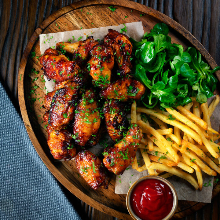 Sweet and spicy honey and sriracha glazed chicken wings served with fries.