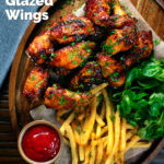 Overhead honey and sriracha glazed chicken wings served with French fries, featuring a title overlay.