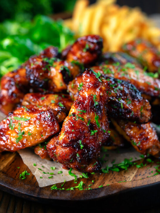 Honey and sriracha glazed chicken wings served with French fries.