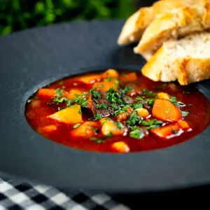Gulyásleves a traditional Hungarian beef goulash soup served with bread.