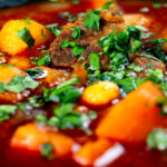 Close-up traditional Hungarian goulash soup or gulyásleves with csipetke (pasta).