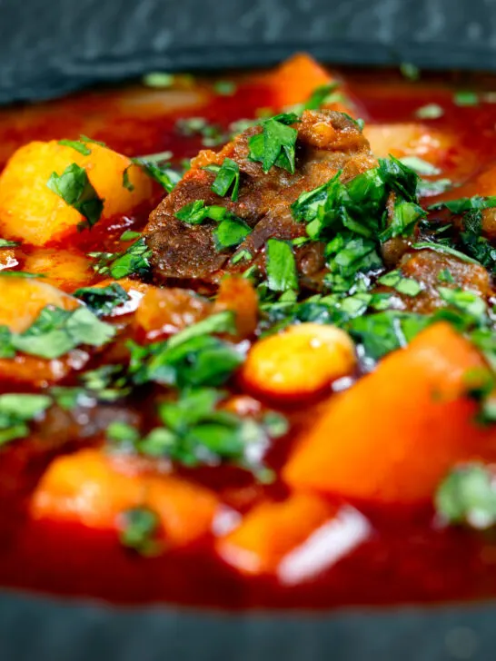 Close-up traditional Hungarian goulash soup or gulyásleves with csipetke (pasta).