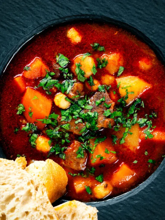 Close-up overhead traditional Hungarian goulash soup or gulyásleves with csipetke (pasta).