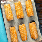 Overhead pork and apple sausage rolls with hot crusty pastry on a baking sheet, featuring a title overlay.