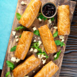 Overhead homemade pork and apple sausage rolls with golden hot crust pastry.