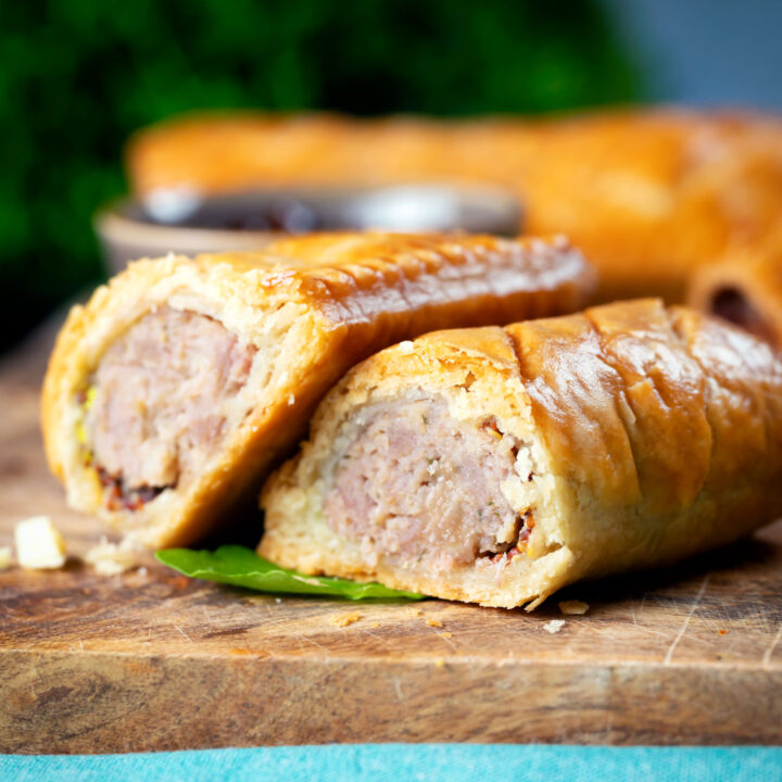 Homemade pork and apple sausage rolls in hot crust pastry.