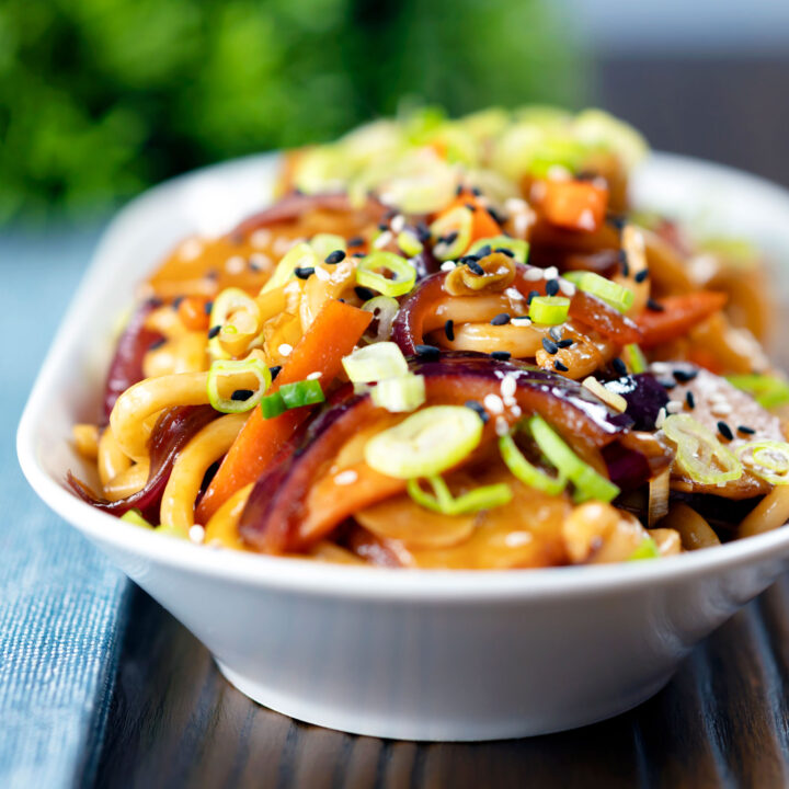 Vegan sweet and sour stir fried udon noodles with vegetables.