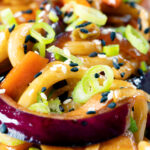 Close-up vegan sweet and sour vegetable and udon noodles stir fry.