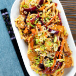 Overhead vegan sweet and sour vegetable and udon noodles stir fry.