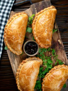 Overhead Traditional Cornish pasty served with chutney.