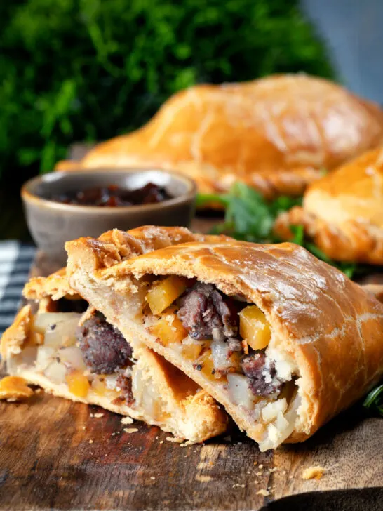 Traditional Cornish pasty cut open to show filling of beef, swede, potato and onions.