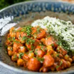 Indian carrot and chickpeas curry in a thick coconut milk sauce served with rice.