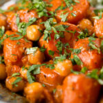 Close-up Indian carrot and chickpeas curry in a thick coconut milk sauce.