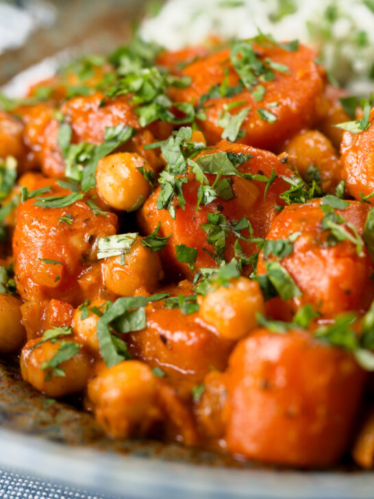 Close-up Indian carrot and chickpeas curry in a thick coconut milk sauce.