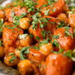 Close-up Indian carrot and chickpeas curry in a thick coconut milk sauce.