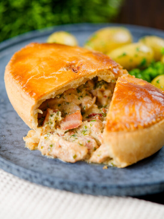 Homemade creamy chicken and bacon pie with peas and buttered potatoes.