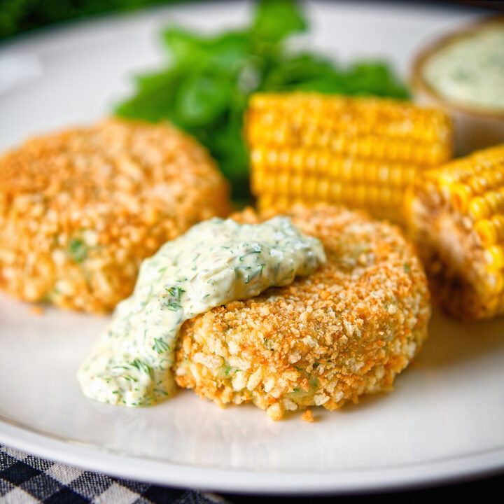 Oven baked grab cakes served with tartar sauce and buttered corn on the cob.