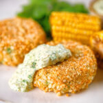 Baked crab cakes with fennel and chives served with homemade tartar sauce.