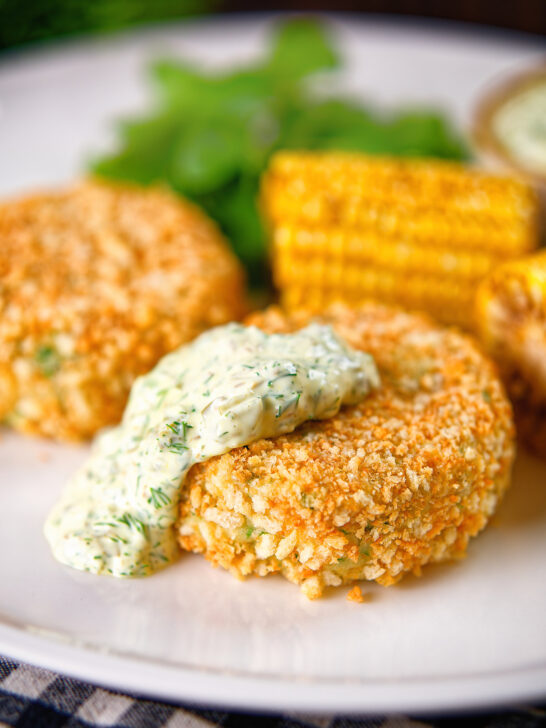 Baked crab cakes with fennel and chives served with homemade tartar sauce.