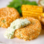 Baked crab cakes with fennel and chives served with homemade tartar sauce.