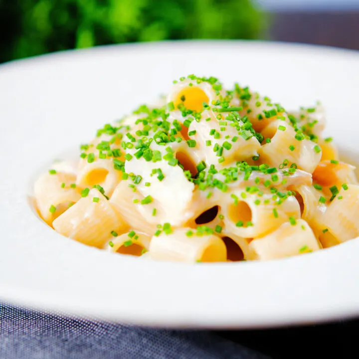 Creamy cheesy smoked haddock pasta garnished with snipped chives.