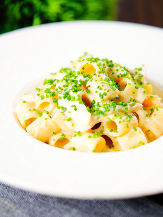 Creamy cheesy smoked haddock pasta made with penne garnished with snipped chives.