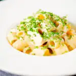 Creamy cheesy smoked haddock pasta made with penne garnished with snipped chives.