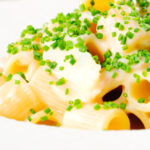Close-up creamy cheesy smoked haddock pasta made with penne.
