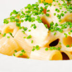 Close-up creamy cheesy smoked haddock pasta made with penne.