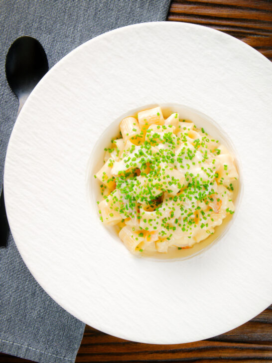 Overhead creamy cheesy smoked haddock pasta made with penne.