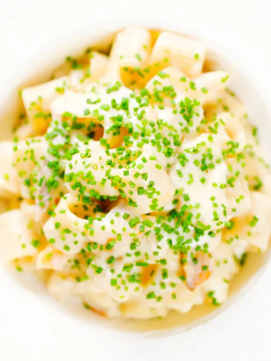 Close-up overhead creamy cheesy smoked haddock pasta made with penne.