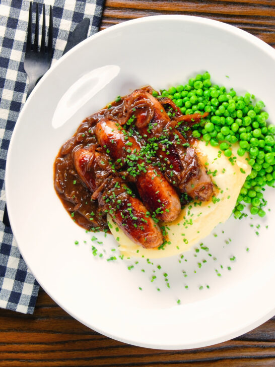 Overhead devilled sausages in a spicy onion gravy with mashed potato and peas.