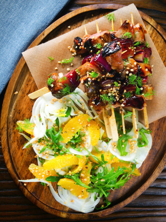 Overhead marmalade glazed duck kebabs served with a fennel and orange salad.