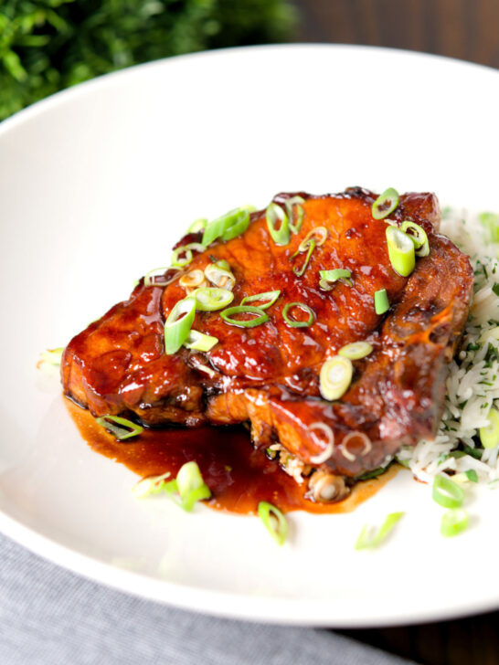 Filipino inspired adobo pork chops served with rice and spring onions.