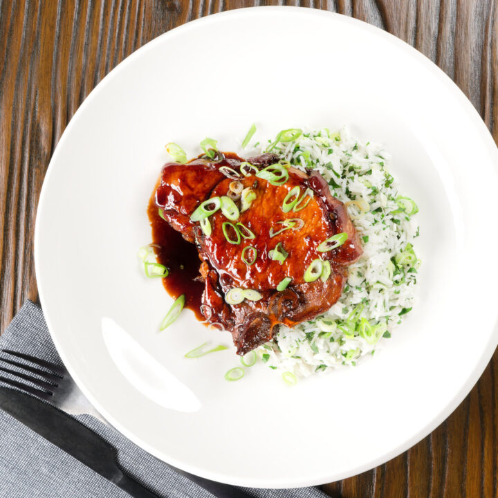 Filipino-inspired adobo pork chops with coriander and spring onion rice.