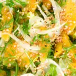 Overhead close-up fennel and orange salad with roasted almonds and rocket.