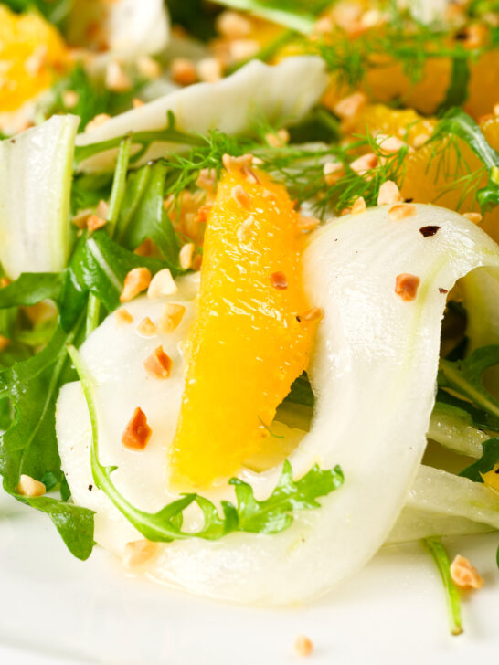 Close-up fennel and orange side salad with roasted almonds and rocket.