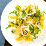 Overhead fennel and orange side salad with roasted almonds and rocket.