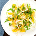 Overhead fennel and orange side salad with roasted almonds and rocket.