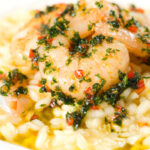 Close-up lemon and prawn risotto with chilli and parsley.