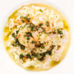 Close-up overhead lemon and prawn risotto with chilli and parsley.