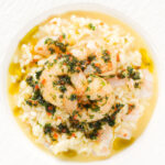 Close-up overhead lemon and prawn risotto with chilli and parsley.