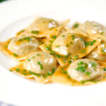 Homemade mushroom filled ravioli in a marsala wine, butter and chive sauce.