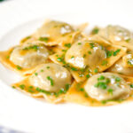 Homemade mushroom filled ravioli in a marsala wine, butter and chive sauce.