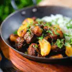 Sri Lankan pork belly curry with tamarind, black pepper and while garlic cloves.