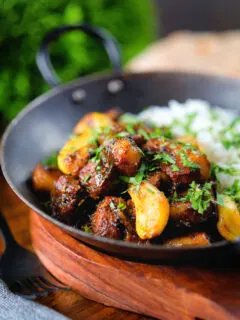 Sri Lankan pork belly curry with tamarind, black pepper and while garlic cloves.