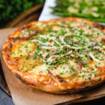 Potato and onion frittata with smoked mackerel and capers served with garlic asparagus.