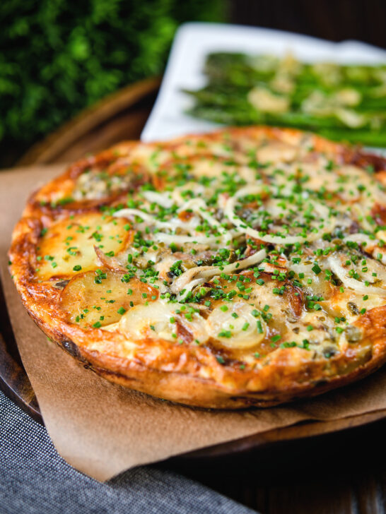 Potato and onion frittata with smoked mackerel and capers served with garlic asparagus.