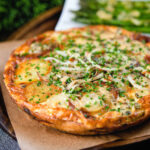 Potato and onion frittata with smoked mackerel and capers served with garlic asparagus.