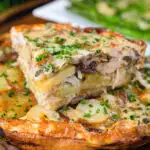 Potato and onion frittata with smoked mackerel and capers cut to show the filling.